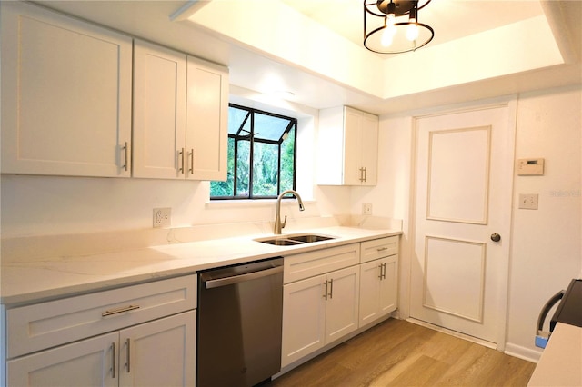 kitchen with light stone countertops, sink, dishwasher, white cabinetry, and light hardwood / wood-style floors