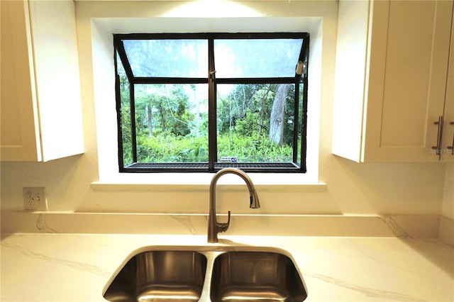 interior details featuring sink and white cabinetry