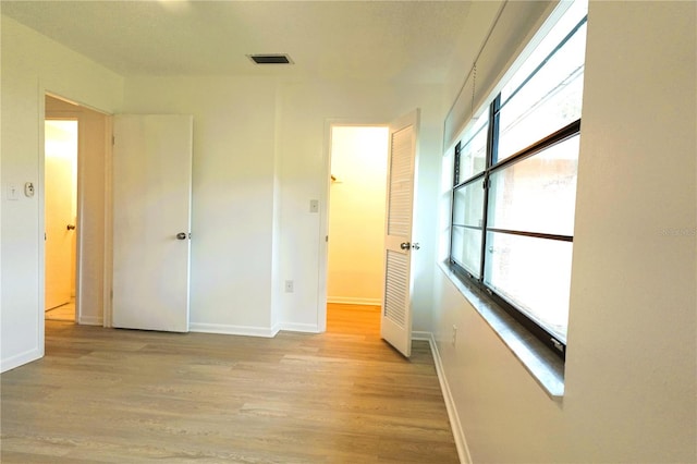 corridor featuring light hardwood / wood-style floors