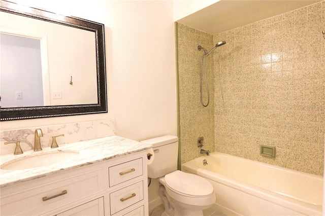 full bathroom featuring vanity, tiled shower / bath, and toilet