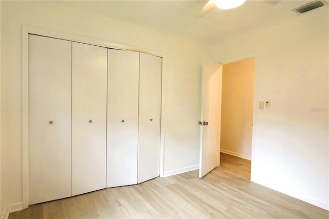 unfurnished bedroom featuring a closet, ceiling fan, and light hardwood / wood-style flooring