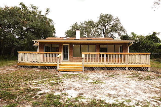 rear view of house with a wooden deck