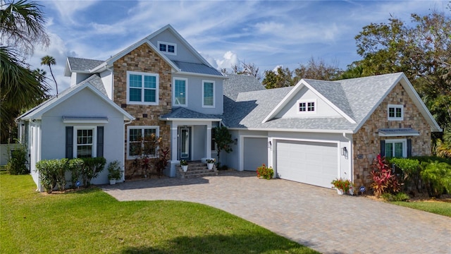 view of front of home featuring a garage and a front lawn