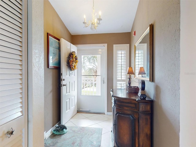 tiled foyer with a notable chandelier and vaulted ceiling