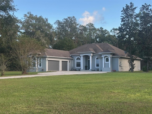 ranch-style home featuring a garage and a front yard