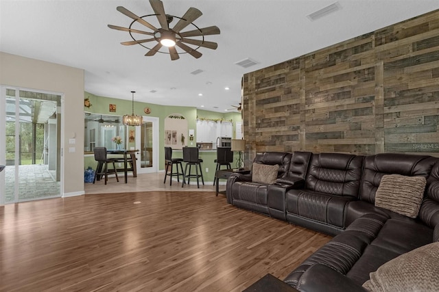 living room with hardwood / wood-style floors and ceiling fan