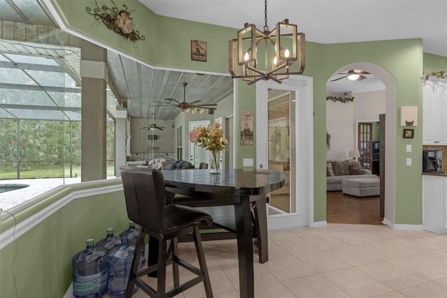 tiled dining area with an inviting chandelier