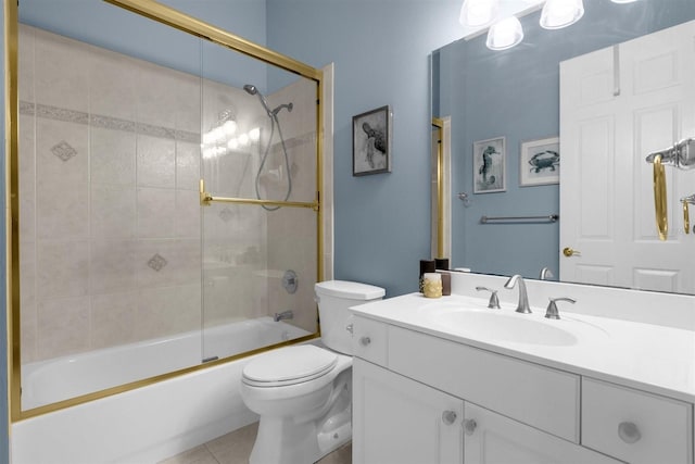 full bathroom with enclosed tub / shower combo, tile patterned floors, vanity, and toilet