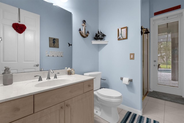 bathroom with a shower with shower door, vanity, toilet, and tile patterned floors