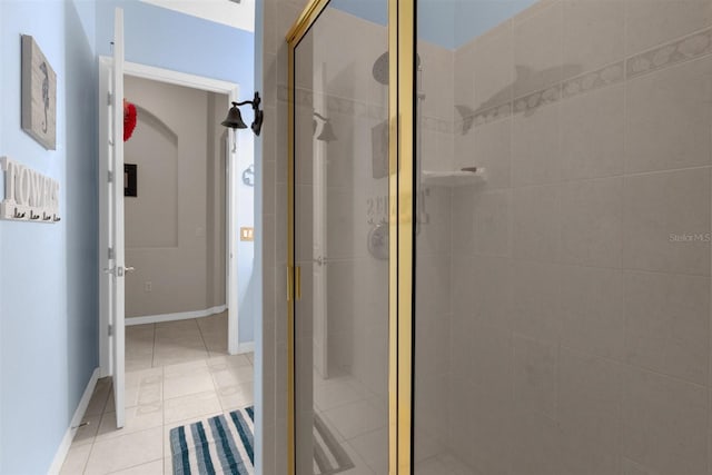 bathroom with tile patterned flooring and a shower with door