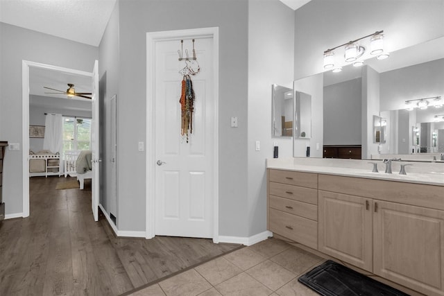 bathroom featuring a textured ceiling, hardwood / wood-style floors, vanity, and ceiling fan