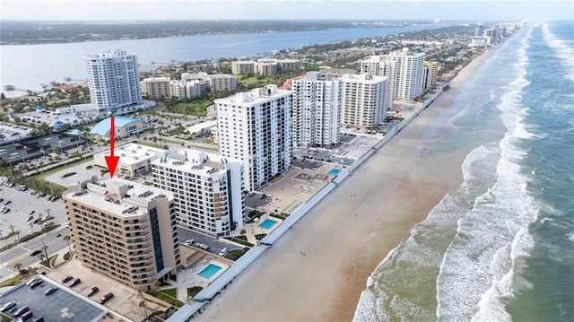 aerial view with a water view and a beach view