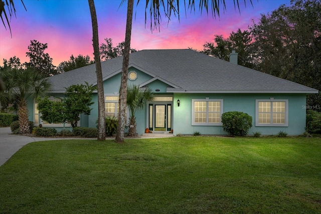 ranch-style house featuring a lawn