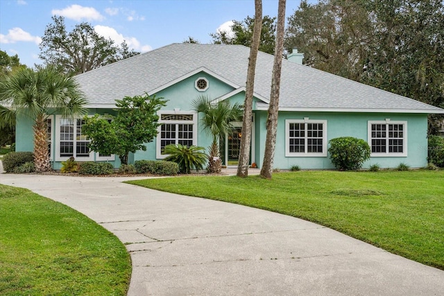 ranch-style house featuring a front lawn