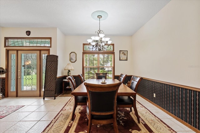 dining area featuring light tile patterned floors and a chandelier