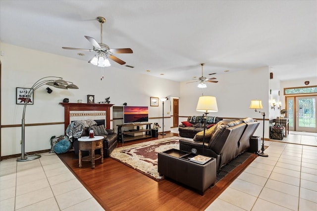 tiled living room featuring ceiling fan