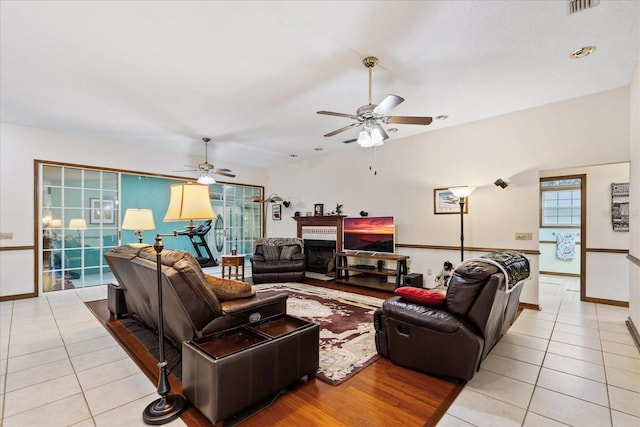 tiled living room with ceiling fan