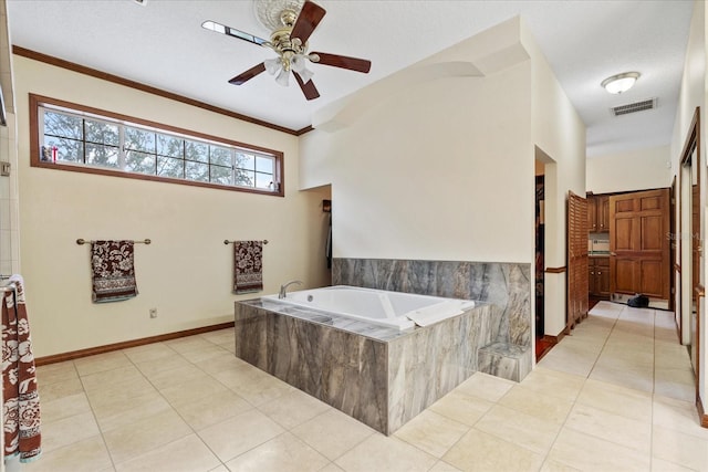 bathroom featuring ceiling fan, ornamental molding, tile patterned flooring, and tiled tub