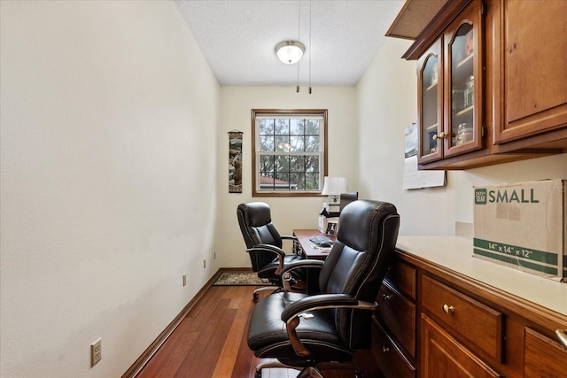 home office featuring hardwood / wood-style floors and a textured ceiling