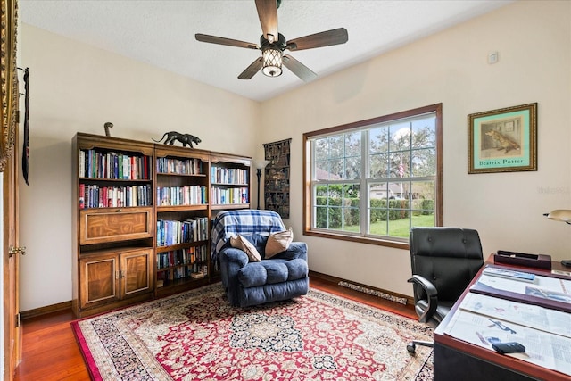 home office with hardwood / wood-style floors and ceiling fan