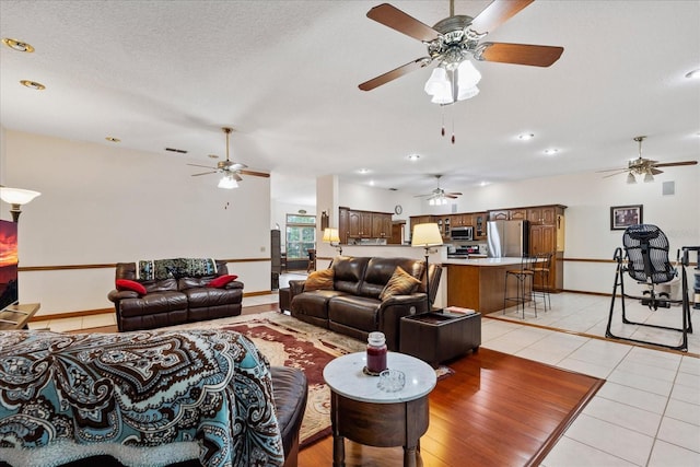 tiled living room with vaulted ceiling and a textured ceiling