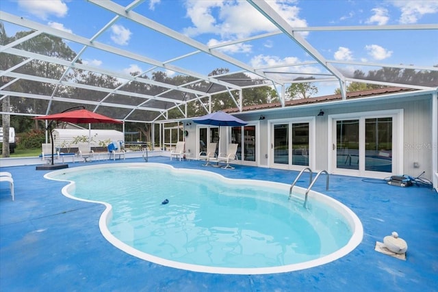 view of swimming pool featuring a patio, french doors, and a lanai