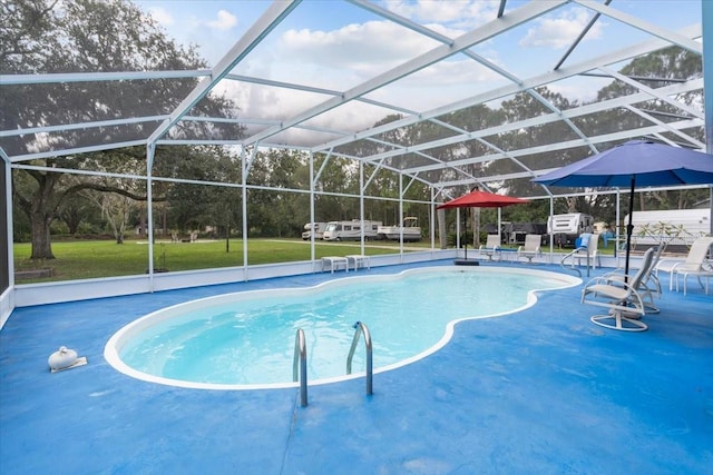 view of swimming pool with glass enclosure, a lawn, and a patio