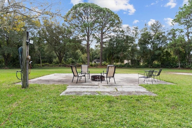 view of yard with a fire pit and a patio area