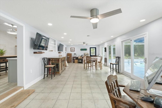 tiled dining space with ceiling fan