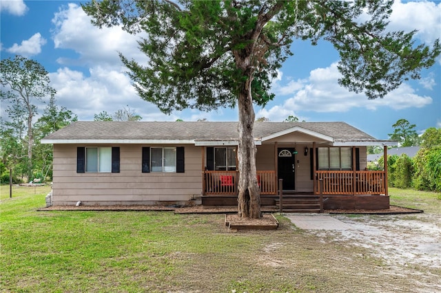 ranch-style house with a front yard and a porch