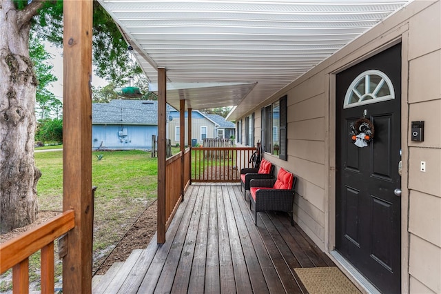 wooden terrace with a yard