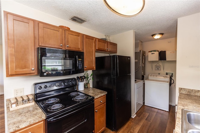 kitchen with a textured ceiling, separate washer and dryer, black appliances, and dark wood-type flooring