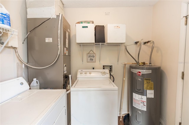 clothes washing area featuring water heater and separate washer and dryer