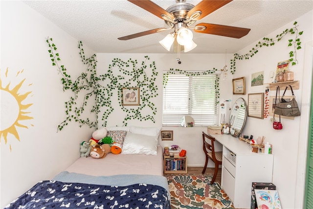 bedroom with a textured ceiling and ceiling fan