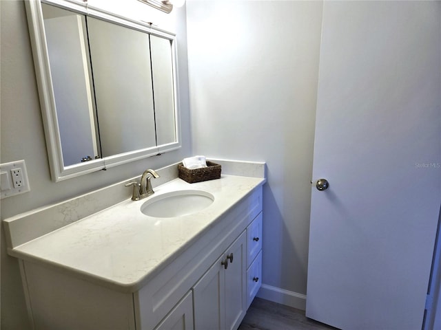 bathroom with hardwood / wood-style floors and vanity