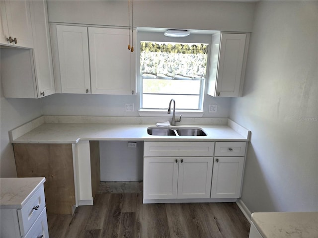 kitchen featuring white cabinets, sink, and dark wood-type flooring