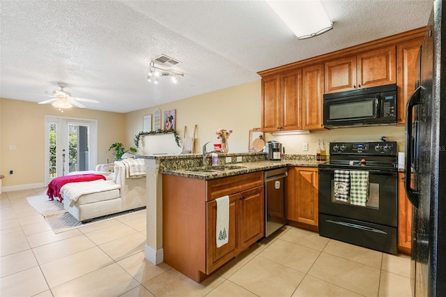 kitchen featuring black appliances, kitchen peninsula, sink, and a textured ceiling