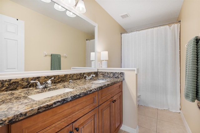 bathroom featuring tile patterned flooring, vanity, and toilet