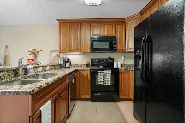 kitchen featuring kitchen peninsula, a textured ceiling, sink, black appliances, and light tile patterned floors