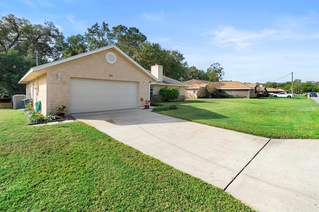 ranch-style house with a garage and a front lawn