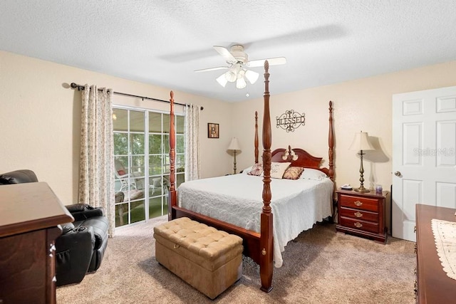 bedroom featuring ceiling fan, a textured ceiling, and light colored carpet