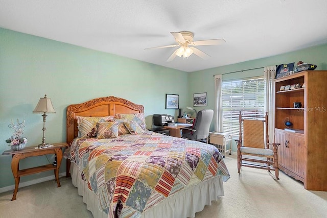 bedroom featuring light colored carpet and ceiling fan