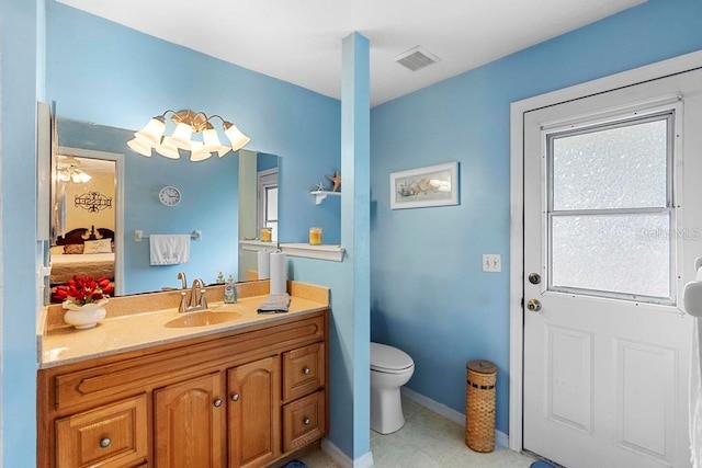 bathroom with vanity and toilet