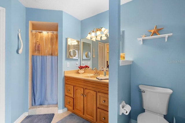 bathroom featuring toilet, vanity, and walk in shower