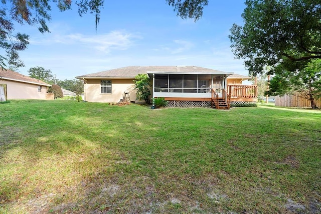 back of house with a sunroom, a yard, and a wooden deck