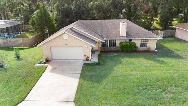 view of front of property with a garage and a front lawn