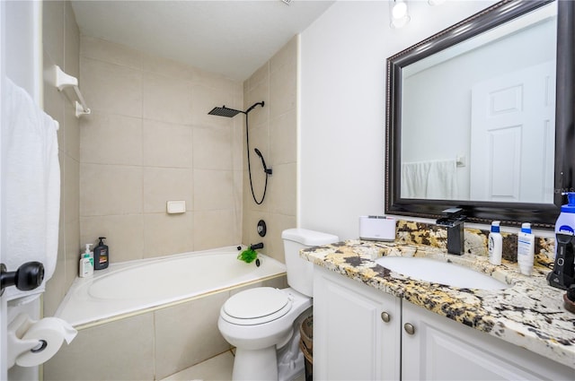 full bathroom featuring tiled shower / bath, toilet, and vanity