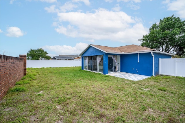 1171 Daimler Dr, Apopka, FL 32712 - rear view of house with stucco siding, a patio area, and a sunroom