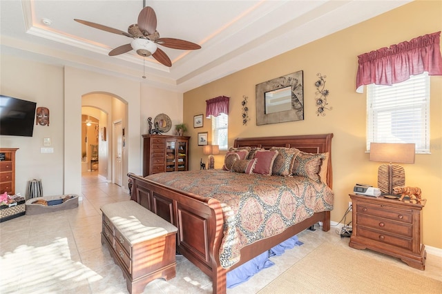 bedroom with a raised ceiling, ceiling fan, crown molding, and light tile patterned flooring