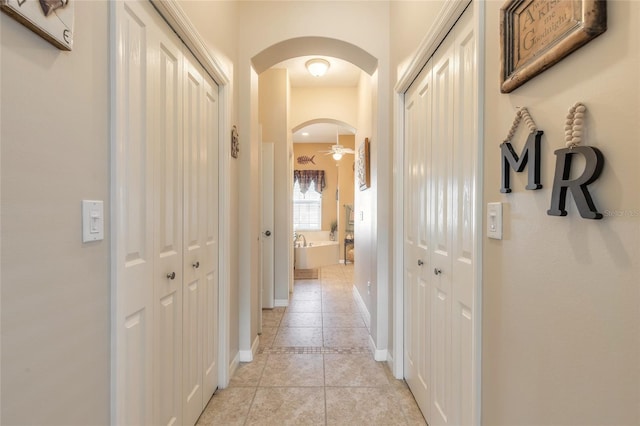 corridor with light tile patterned flooring